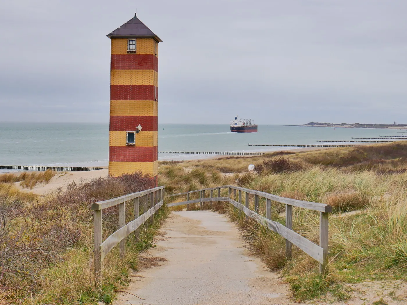 Vlissingen, on the coast of Zeeland, Netherlands. A spring evening at low tide. The North Sea is calm, the wind almost gone, the waves washing in soft and friendly. Children play on the sand, voices carrying in the still air. Terns and gulls pass overhead. From a neighboring balcony, the murmur of conversation. Far out at sea, the low hum of a passing ship. As the sun sets, the beach empties, doors close, and the Dutch coast settles into evening.